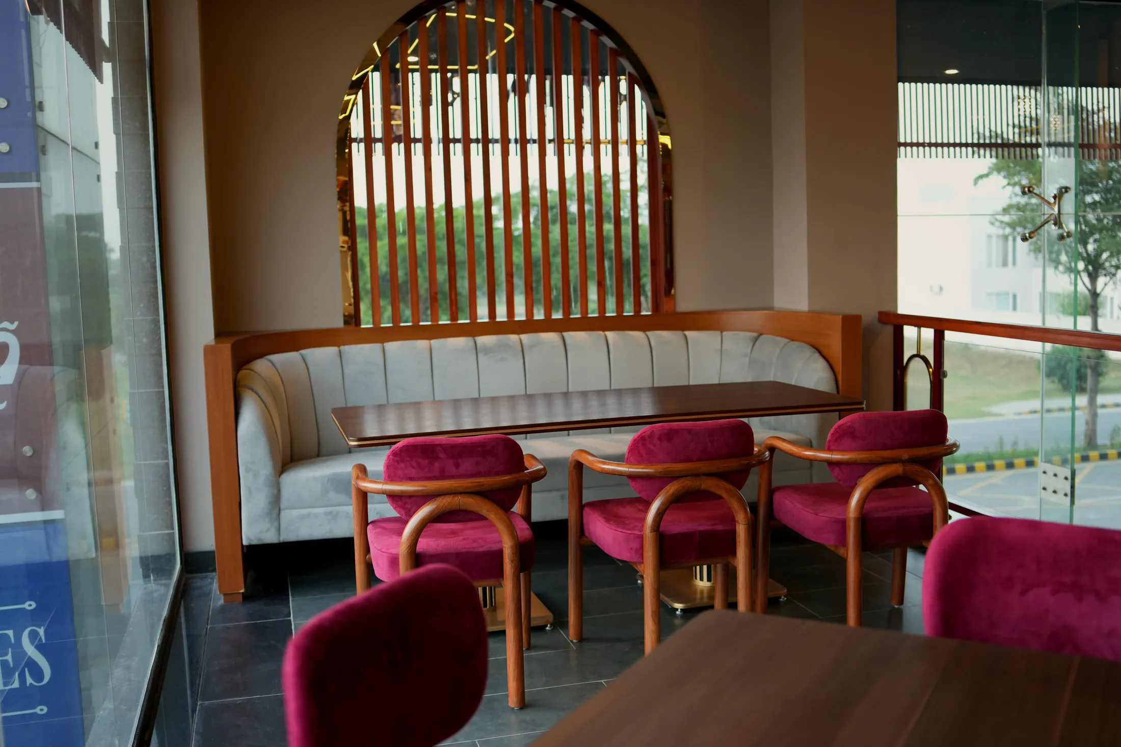 Velvet booth beneath an arched window at Pasta La Vie