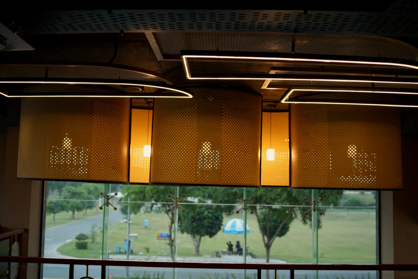 Woven lanterns above tables by the window at Pasta La Vie